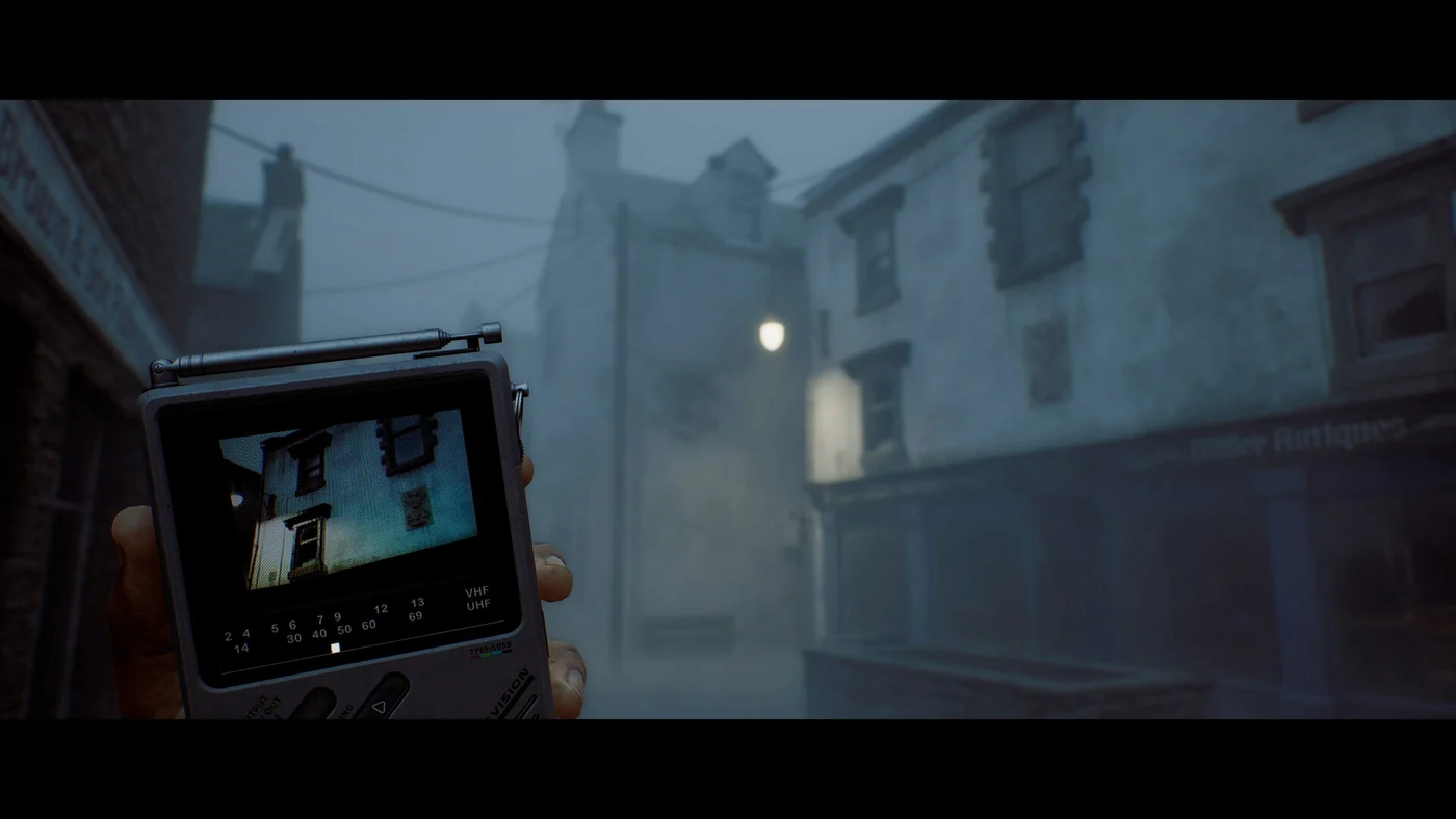 SILENT HILL: Townfall shows a handheld CRTV raised against a foggy street.