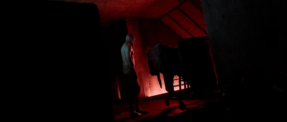 A humanoid figure stands in a dark, red-lit interior in an official Silent Hill: Townfall promotional image.